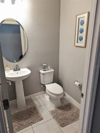 a bedroom with a bed and a dresser with rug