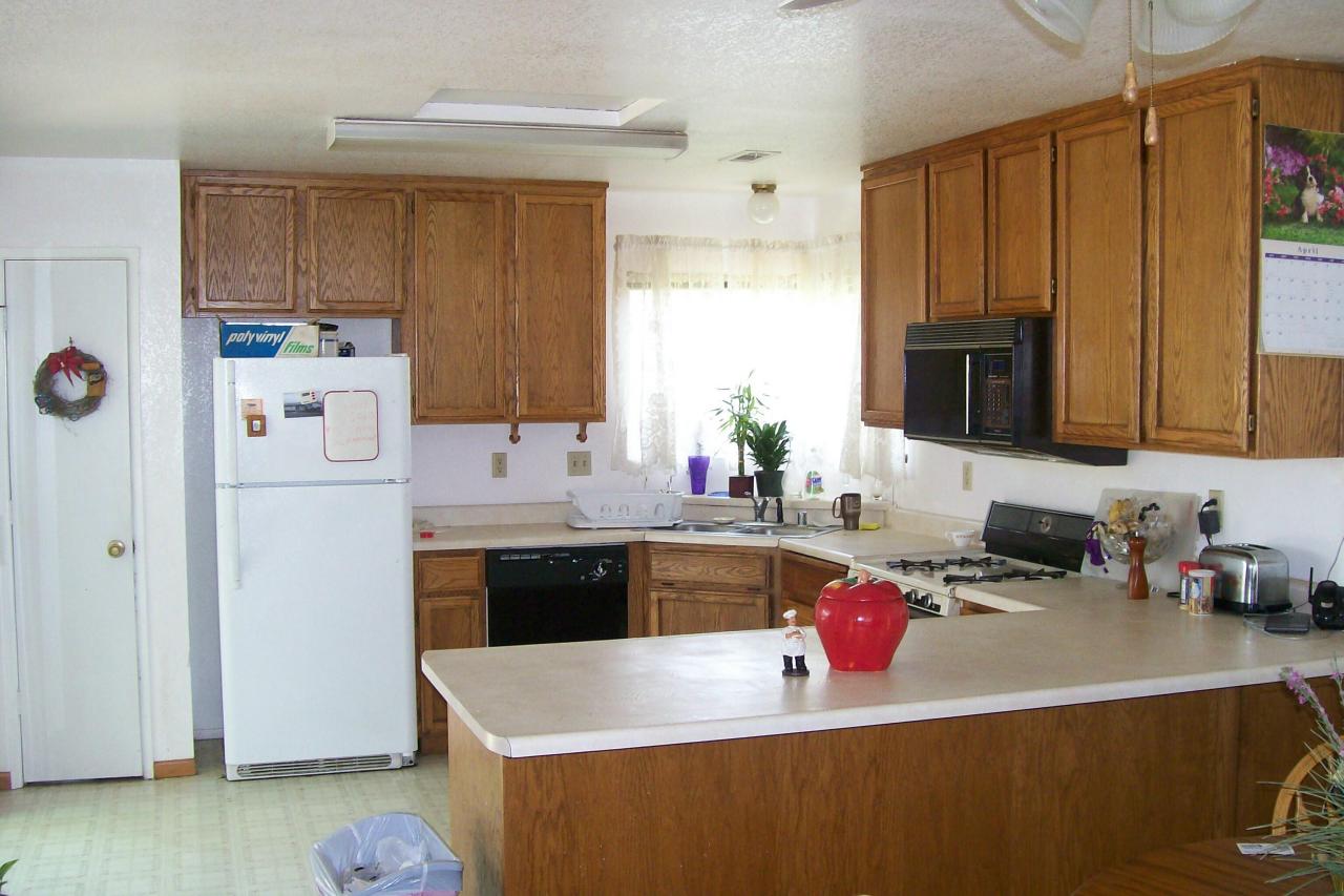 3607 Santa Rosa Way Redding, CA 96003 - Photo 3 of 10 a kitchen with stainless steel appliances granite countertop a sink dishwasher stove top oven and refrigerator with wooden floor