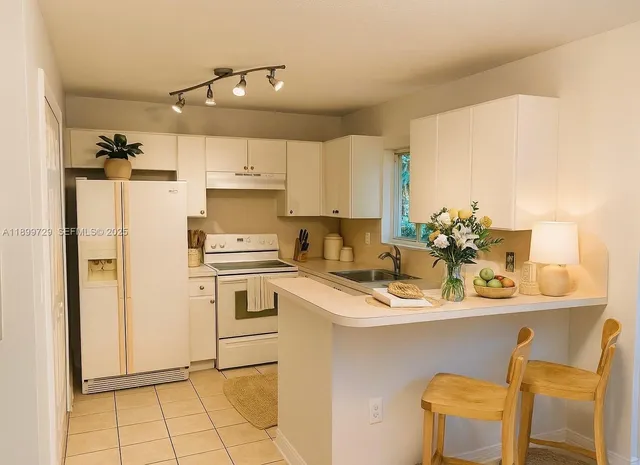 a kitchen with a sink appliances and cabinets