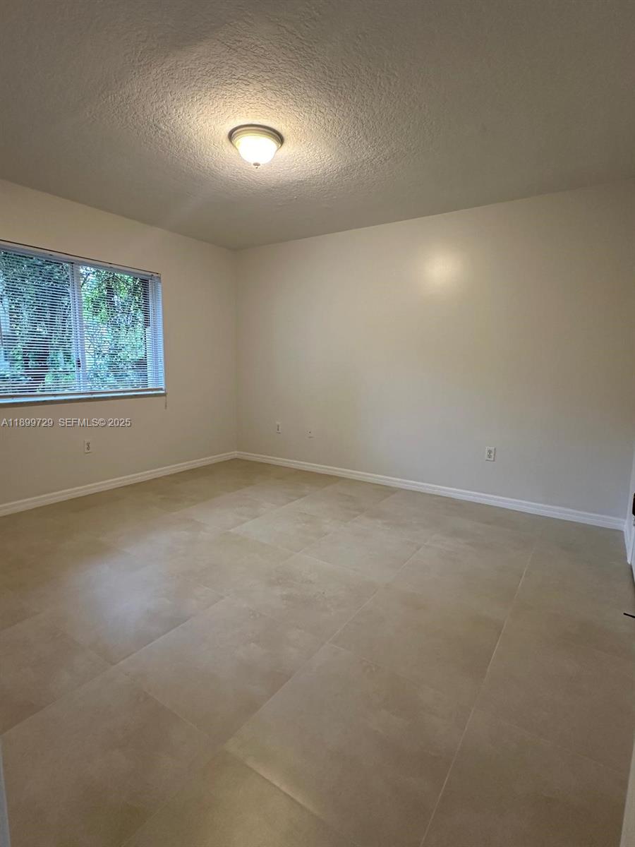 1270 Southeast 28th Court, Unit 101 Homestead, FL 33035 - Photo 20 of 27 an empty room with a window