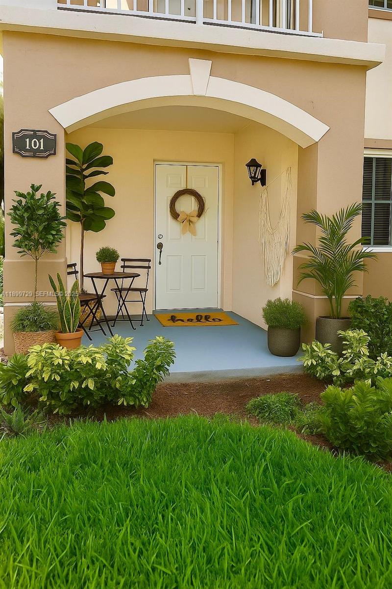 1270 Southeast 28th Court, Unit 101 Homestead, FL 33035 - Photo 2 of 27 a front view of a house with garden