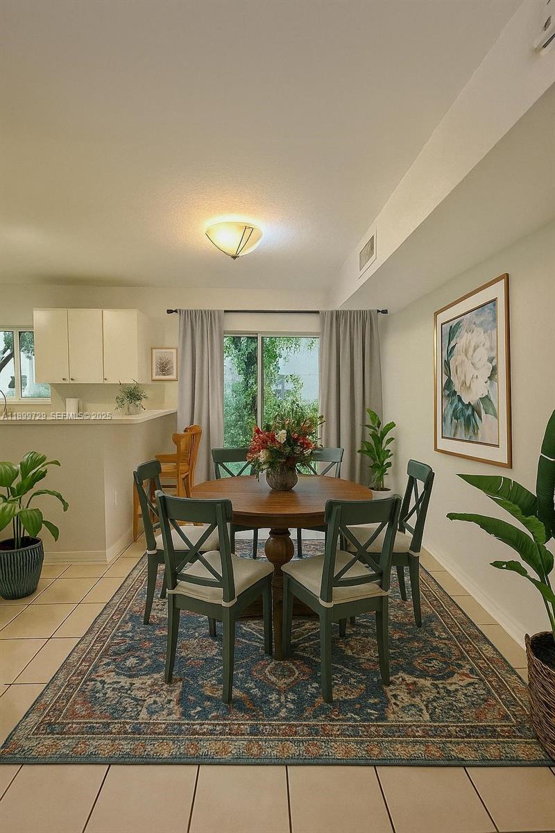 1270 Southeast 28th Court, Unit 101 Homestead, FL 33035 - Photo 3 of 27 a view of a dining room with furniture