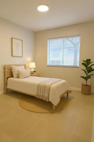 a bedroom with a bed and window