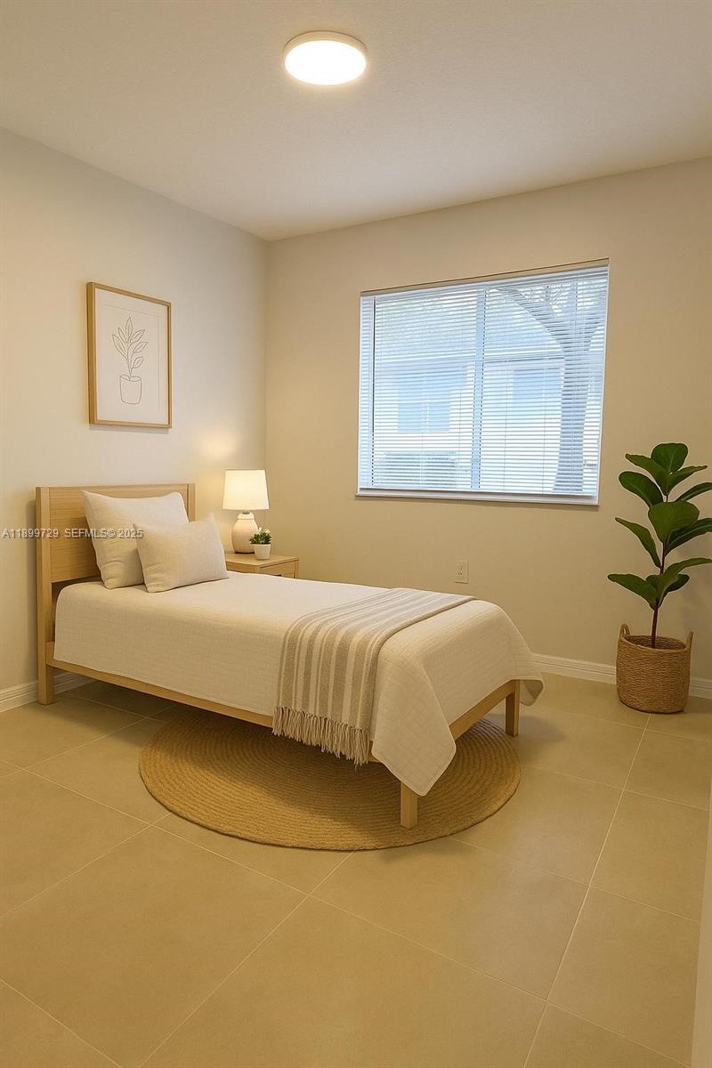 1270 Southeast 28th Court, Unit 101 Homestead, FL 33035 - Photo 6 of 27 a bedroom with a bed and window