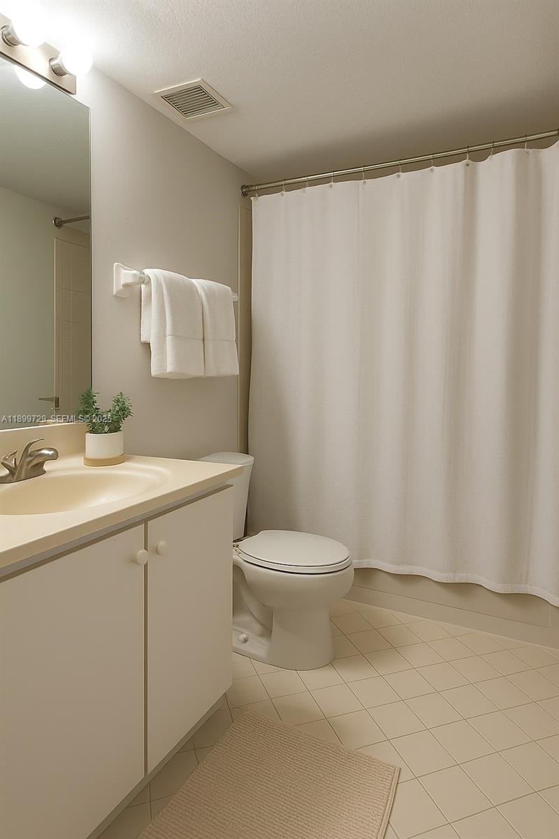 1270 Southeast 28th Court, Unit 101 Homestead, FL 33035 - Photo 9 of 27 a bathroom with a sink a toilet and shower