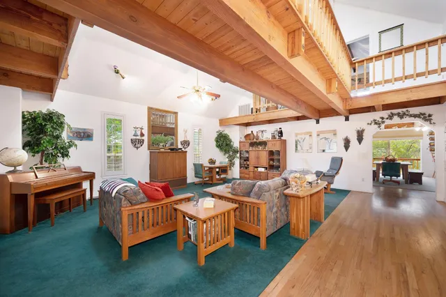 a dining room with furniture a chandelier and wooden floor
