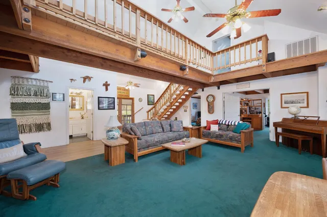 a dining room with furniture and a floor to ceiling window