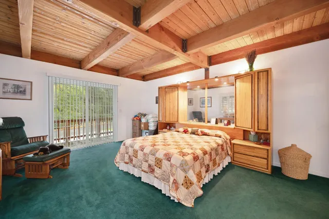 a living room with furniture and floor to ceiling window