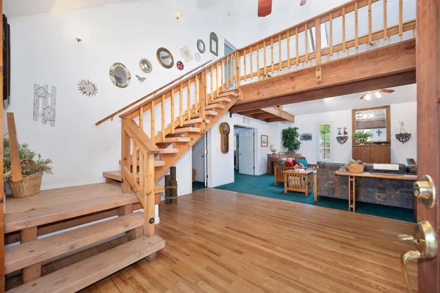 a room with a table chairs and a window