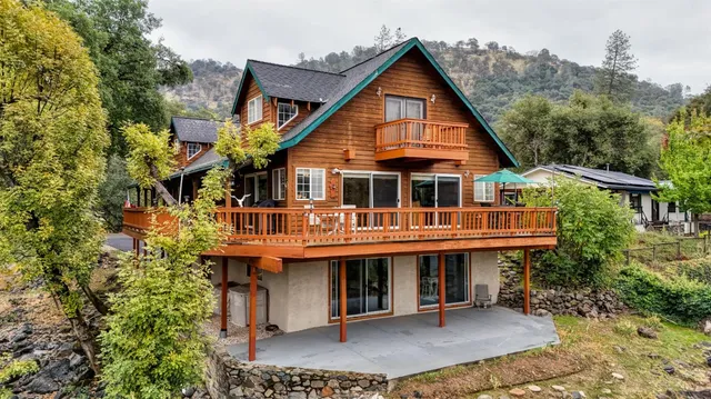 an aerial view of a house with a yard and parking space