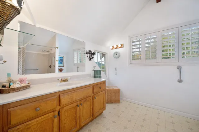 a view of house with a yard and potted plants