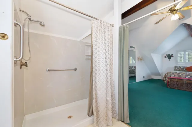 a view of a house with a yard and wooden fence