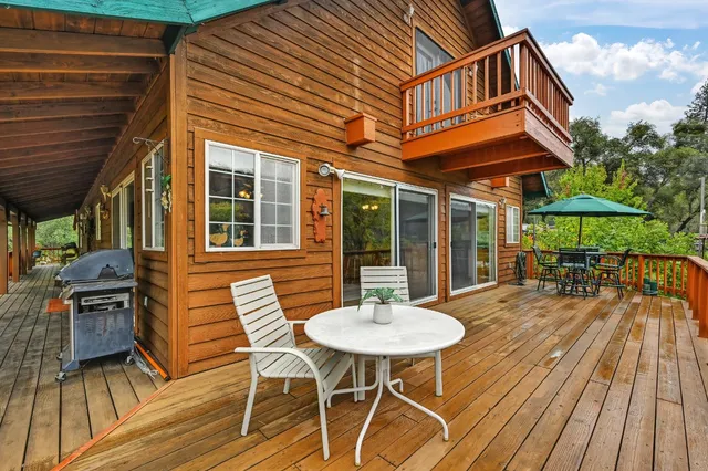an aerial view of a house with a yard and tree s