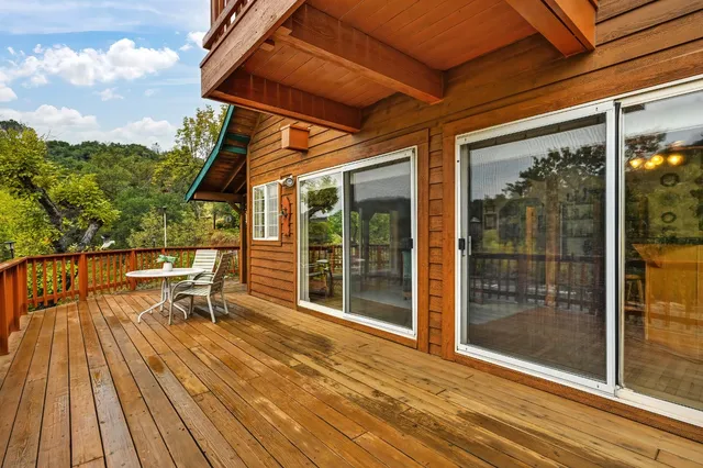 an aerial view of a house with a yard and lake view