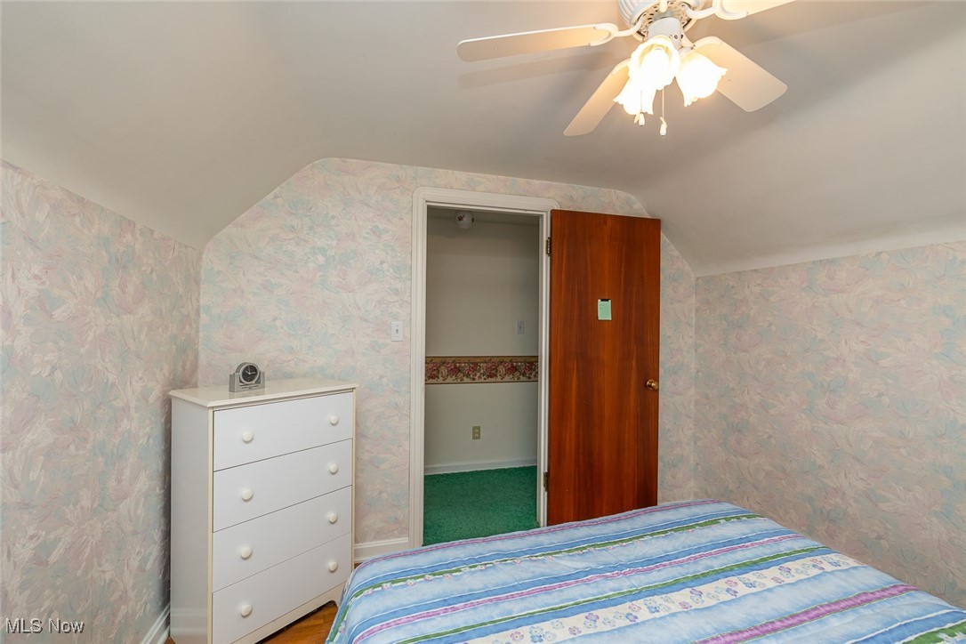 7494 Brecksville Road Independence, OH 44131 - Photo 11 of 20 Bedroom with wallpapered walls, lofted ceiling, and a ceiling fan
