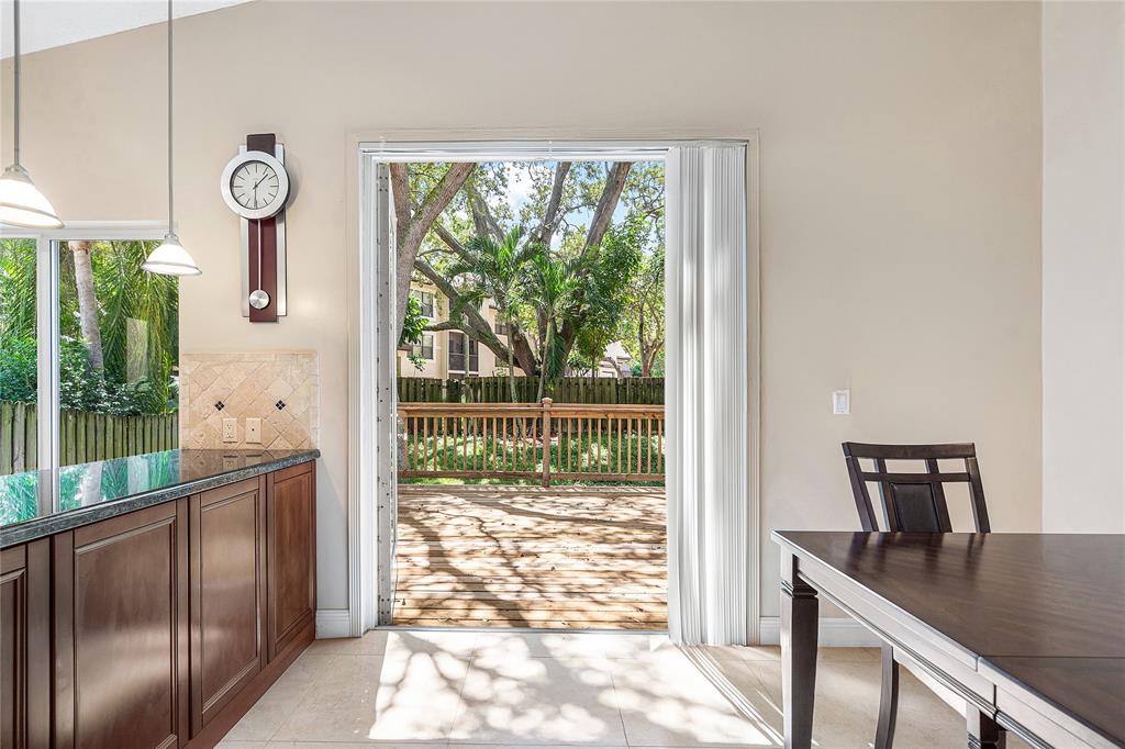 1443 Banyan Circle Pompano Beach, FL 33069 - Photo 12 of 36 a view of a floor to ceiling window and a kitchen