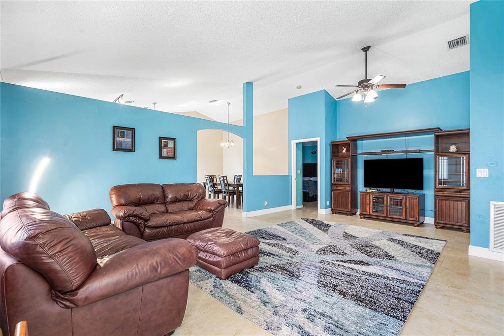 1443 Banyan Circle Pompano Beach, FL 33069 - Photo 13 of 36 a living room with furniture and a flat screen tv
