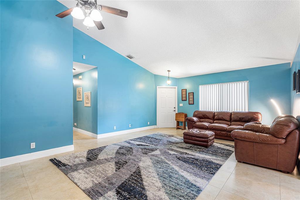 1443 Banyan Circle Pompano Beach, FL 33069 - Photo 15 of 36 a living room with furniture and a chandelier