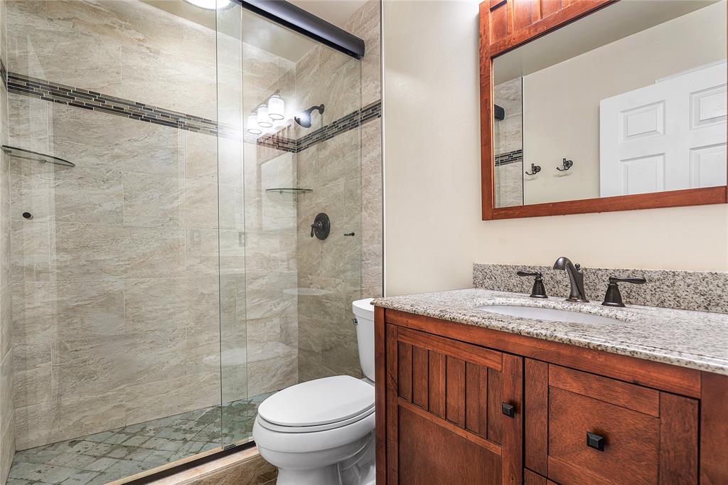1443 Banyan Circle Pompano Beach, FL 33069 - Photo 18 of 36 a bathroom with a granite countertop sink toilet and shower