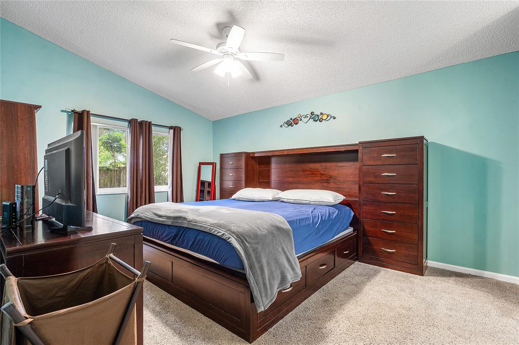 1443 Banyan Circle Pompano Beach, FL 33069 - Photo 22 of 36 a bed room with a bed and a dresser