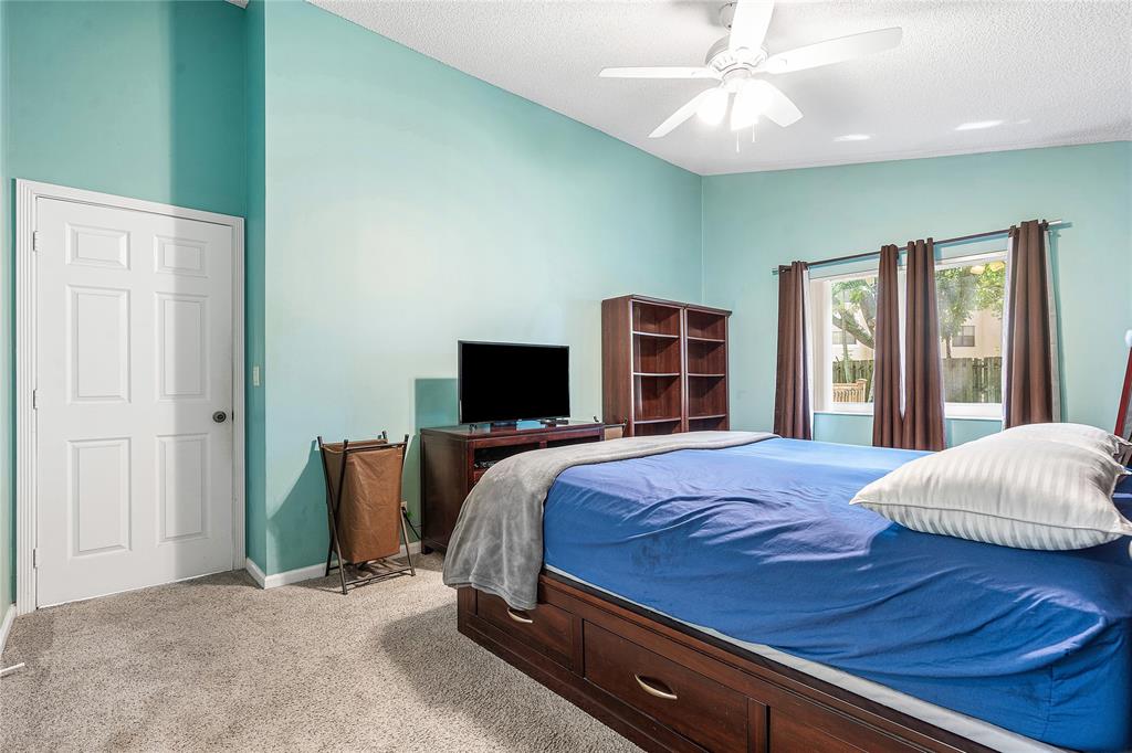 1443 Banyan Circle Pompano Beach, FL 33069 - Photo 23 of 36 a bedroom with a bed and a television