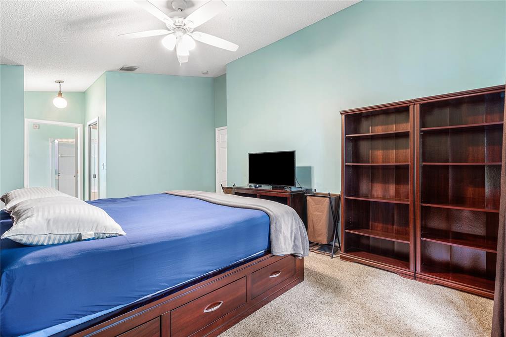 1443 Banyan Circle Pompano Beach, FL 33069 - Photo 24 of 36 a bedroom with a bed and a television