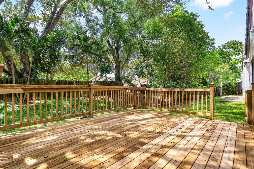1443 Banyan Circle Pompano Beach, FL 33069 - Photo 28 of 36 a balcony with view of trees in the background