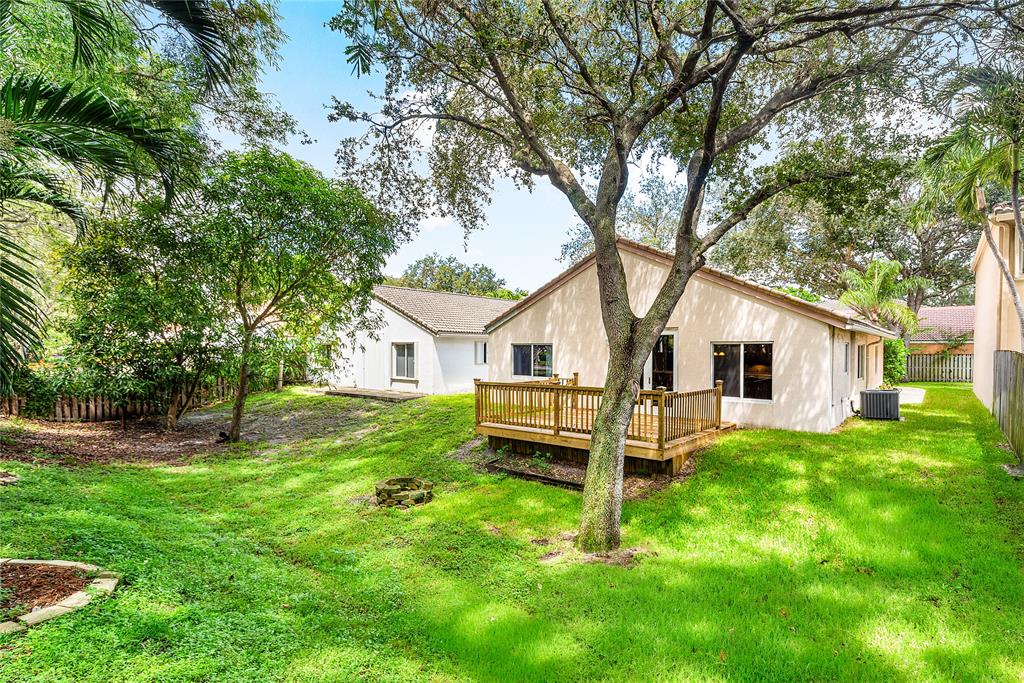 1443 Banyan Circle Pompano Beach, FL 33069 - Photo 30 of 36 a front view of a house with a garden