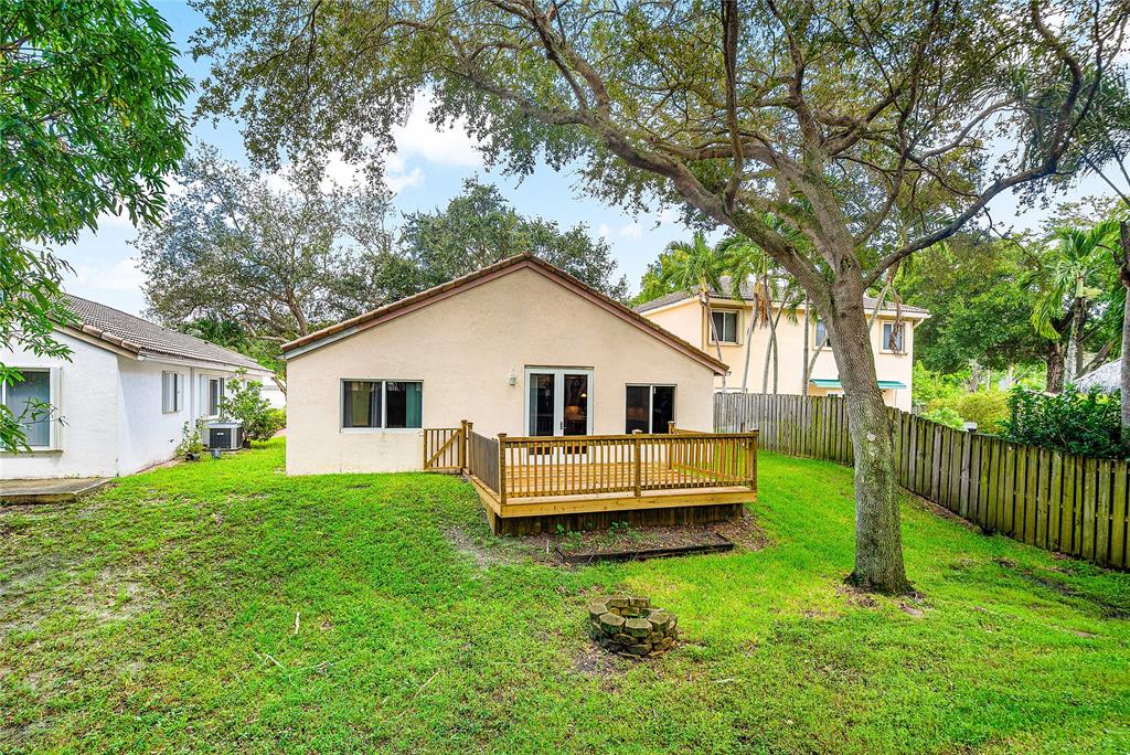 1443 Banyan Circle Pompano Beach, FL 33069 - Photo 32 of 36 a front view of house with yard and green space