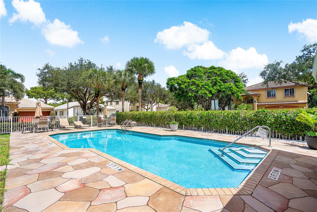1443 Banyan Circle Pompano Beach, FL 33069 - Photo 34 of 36 a view of a swimming pool with a patio