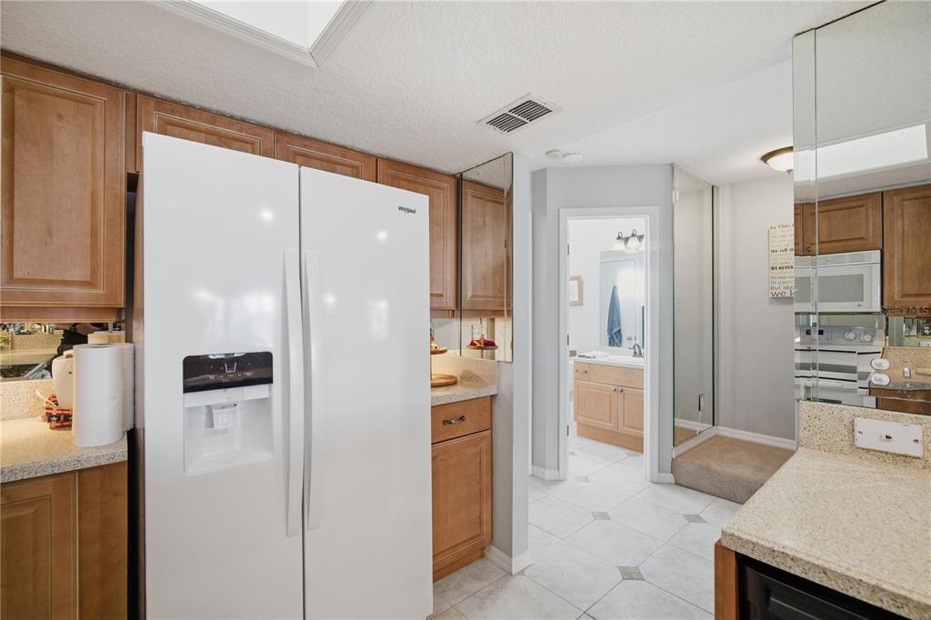 643 Garland Circle Indian Rocks Beach, FL 33785 - Photo 26 of 81 a kitchen with stainless steel appliances a refrigerator and a stove top oven
