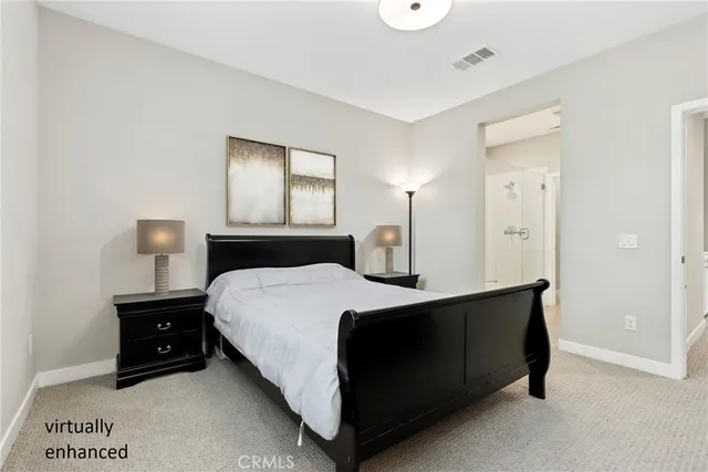 a bedroom with a bed and a night stand