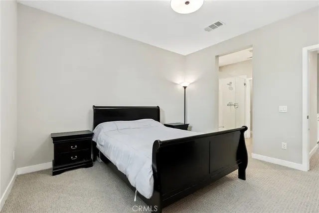 a bed room with a bed and a night stand