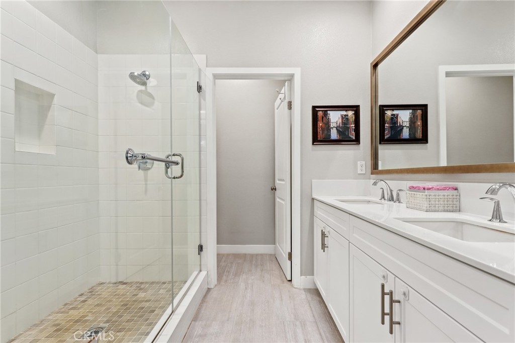 649 West Foothill Boulevard, Unit 2 Glendora, CA 91741 - Photo 19 of 44 a bathroom with a granite countertop sink a mirror and a shower