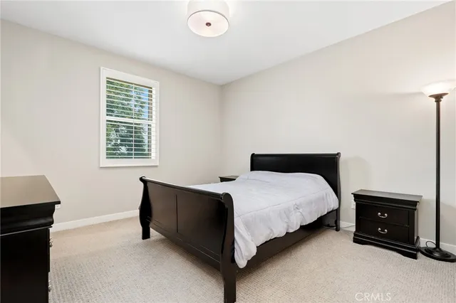 a bedroom with a bed and a tv