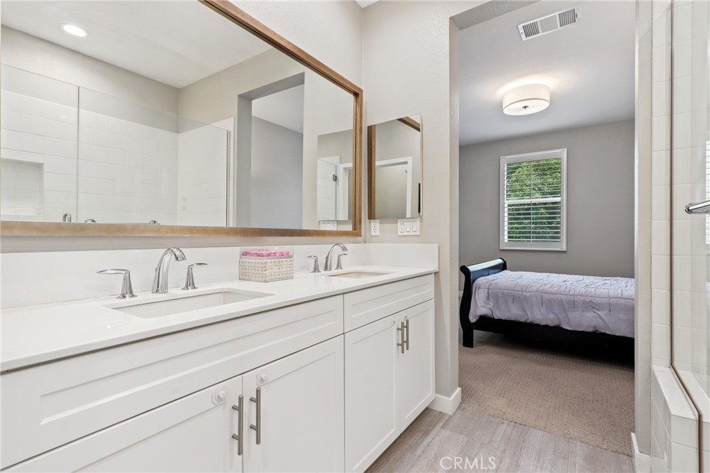 649 West Foothill Boulevard, Unit 2 Glendora, CA 91741 - Photo 20 of 44 a en suite bathroom with a double vanity sink and a mirror