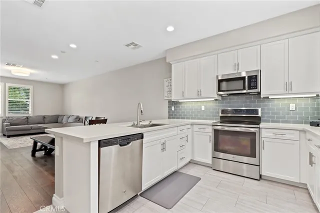a kitchen with a sink stove and microwave