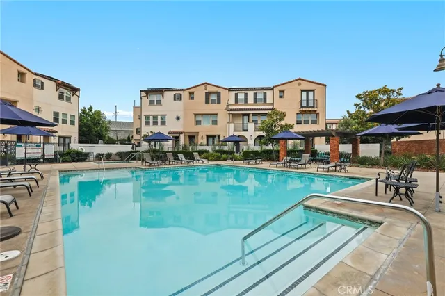 a view of a swimming pool with outdoor seating