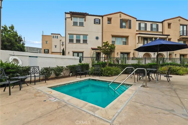 a view of a house with swimming pool and sitting area