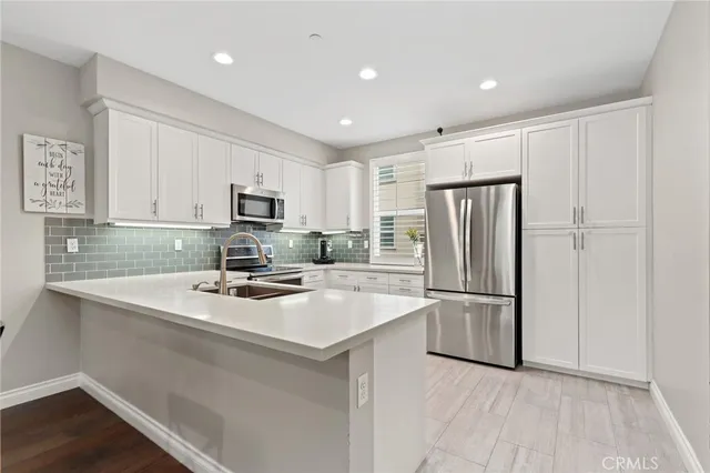 a kitchen with refrigerator cabinets and wooden floor