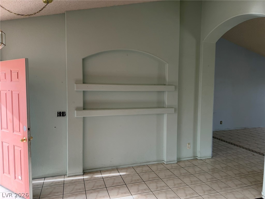 277 Gentle Bay Avenue Henderson, NV 89074 - Photo 18 of 43 This inviting entryway features architectural niches, arched doorways, and durable tiled flooring.