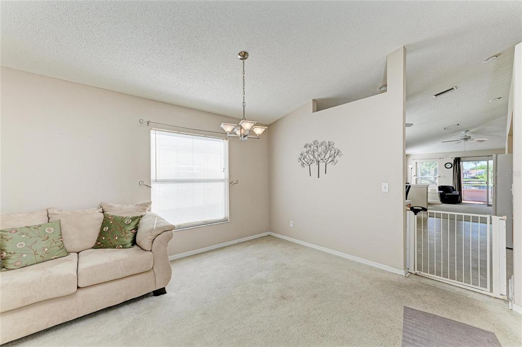 4642 Runabout Way Bradenton, FL 34203 - Photo 13 of 66 a living room with furniture and a chandelier