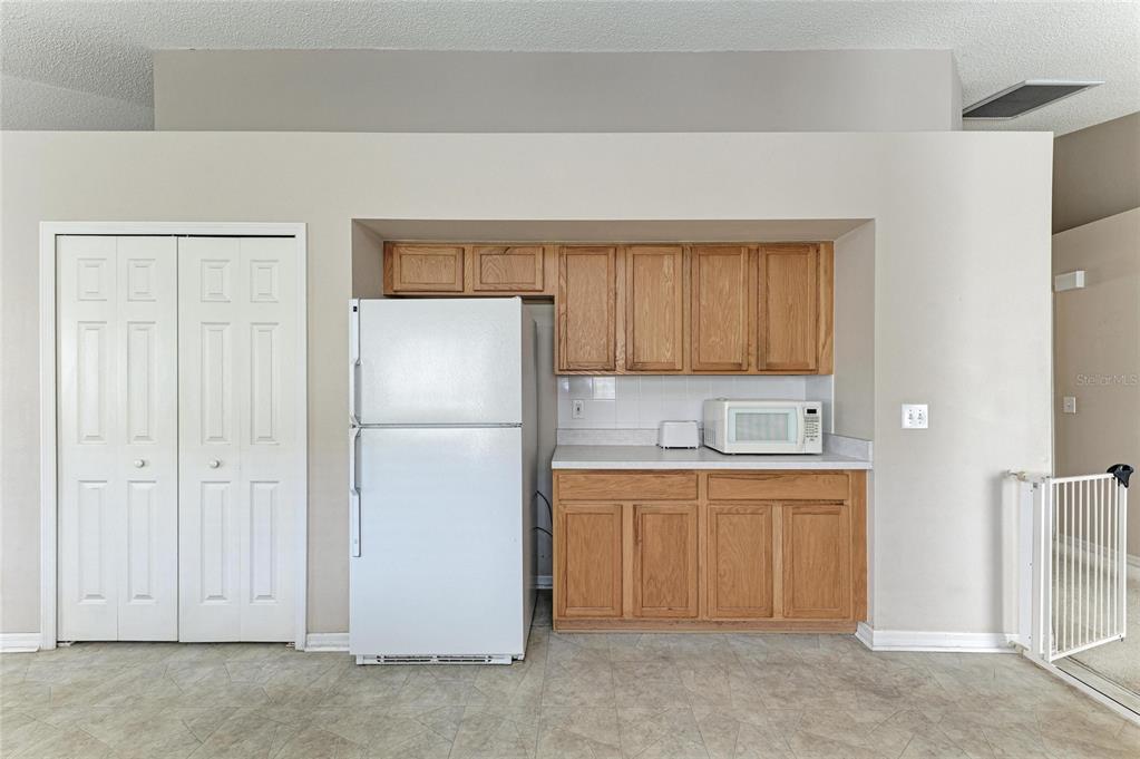 4642 Runabout Way Bradenton, FL 34203 - Photo 18 of 66 a kitchen with a refrigerator a sink and cabinets
