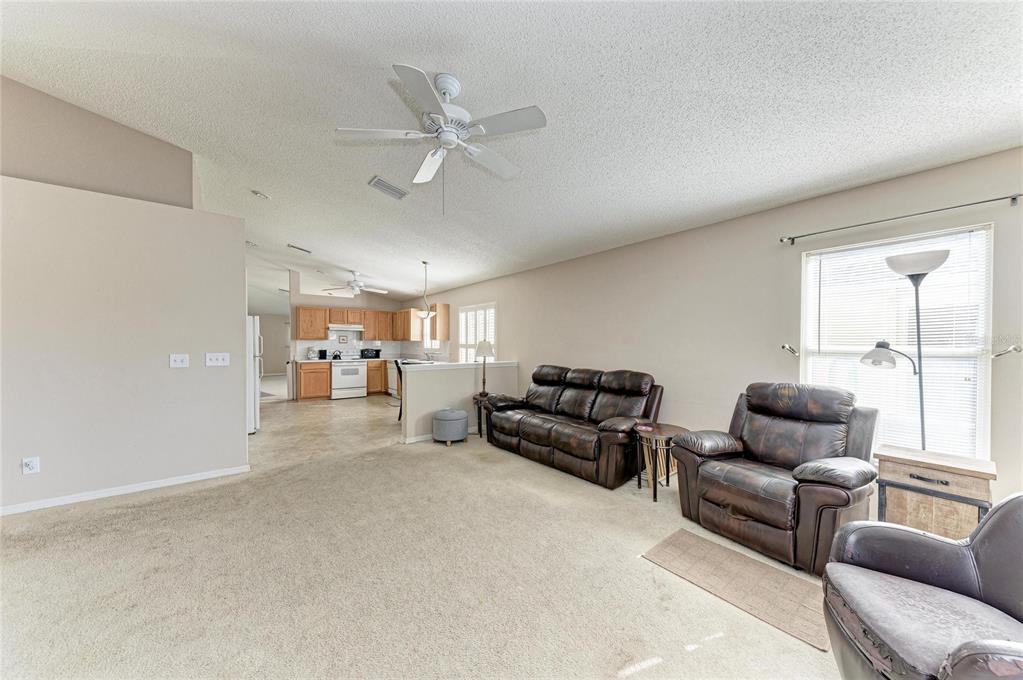 4642 Runabout Way Bradenton, FL 34203 - Photo 24 of 66 a living room with furniture and a large window