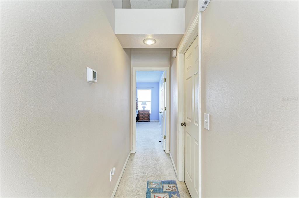 4642 Runabout Way Bradenton, FL 34203 - Photo 35 of 66 a view of a hallway with wooden floor and a bathroom