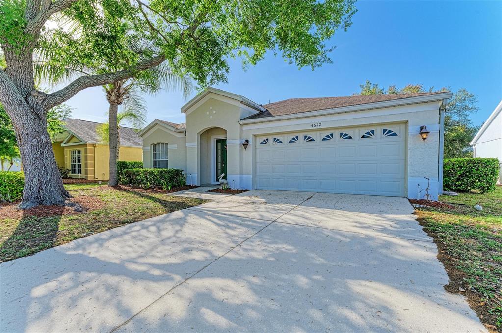 4642 Runabout Way Bradenton, FL 34203 - Photo 5 of 66 a front view of a house with a yard and garage