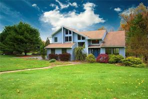 5 Amber Ridge Road Chestnut Ridge, NY 10977 - Photo 1 of 1 a front view of a house with a garden and deck