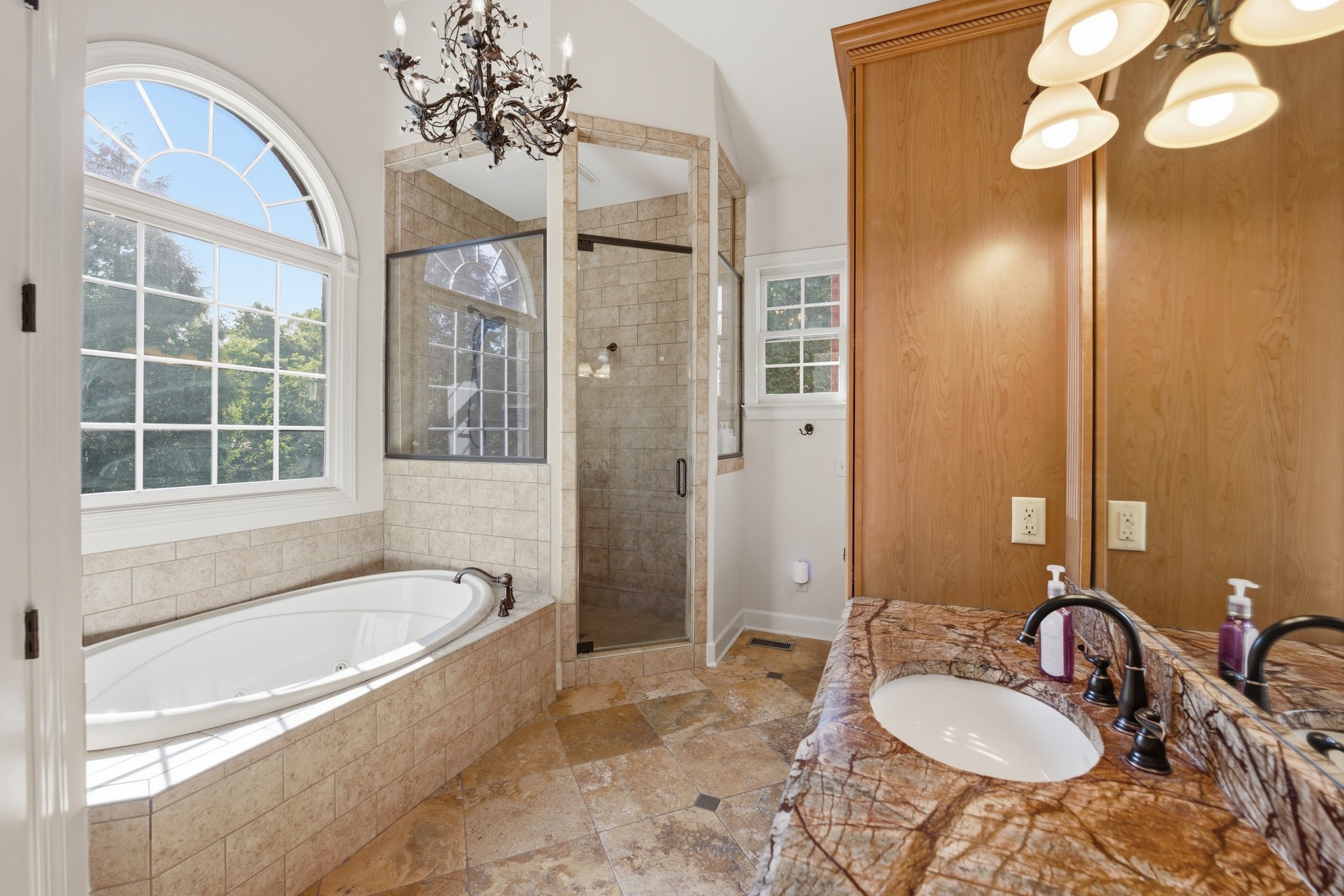 319 Hamlets End Way Franklin, TN 37067 - Photo 29 of 54 a bathroom with a tub sink and mirror