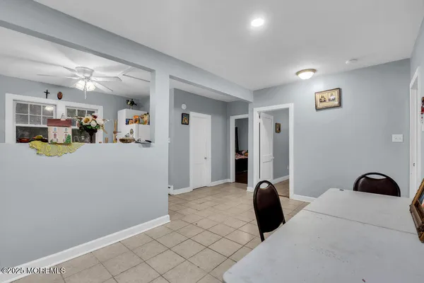 a view of a house with a yard and large tree