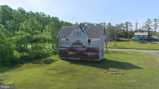 a wooden bench sitting in the middle of a field